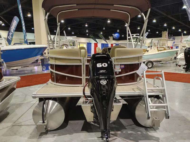 Slide: The Image of 2024 Starcraft EX 18 F pontoon boat with Mercury 60 HP engine at a boat show. - 9