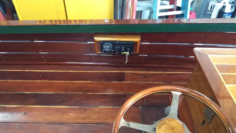 Slide: The Image of Wooden interior of a 1990 Custom 29 Launch boat with steering wheel. - 11