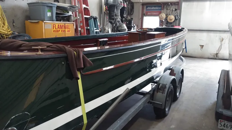 Slide: The Image of Custom 1990 29 Launch boat on trailer in a garage. - 14