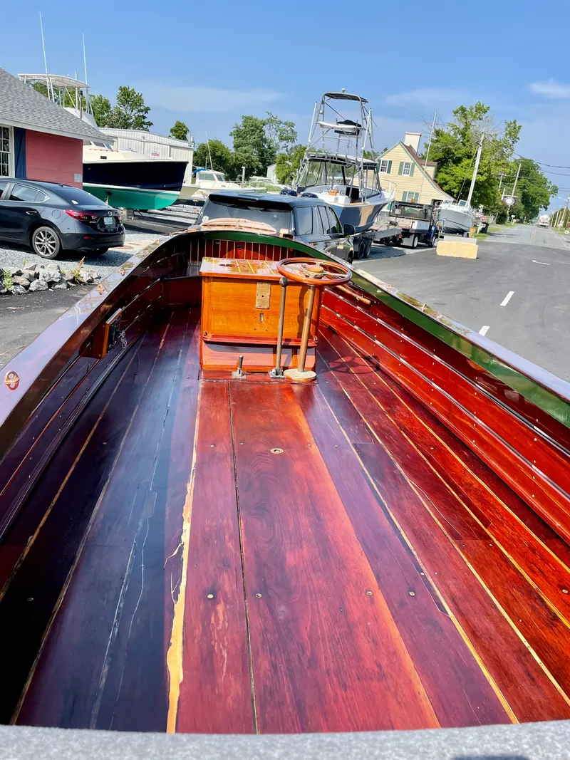 Slide: The Image of Custom 1990 29 Launch boat with polished wooden interior docked at a marina. - 17