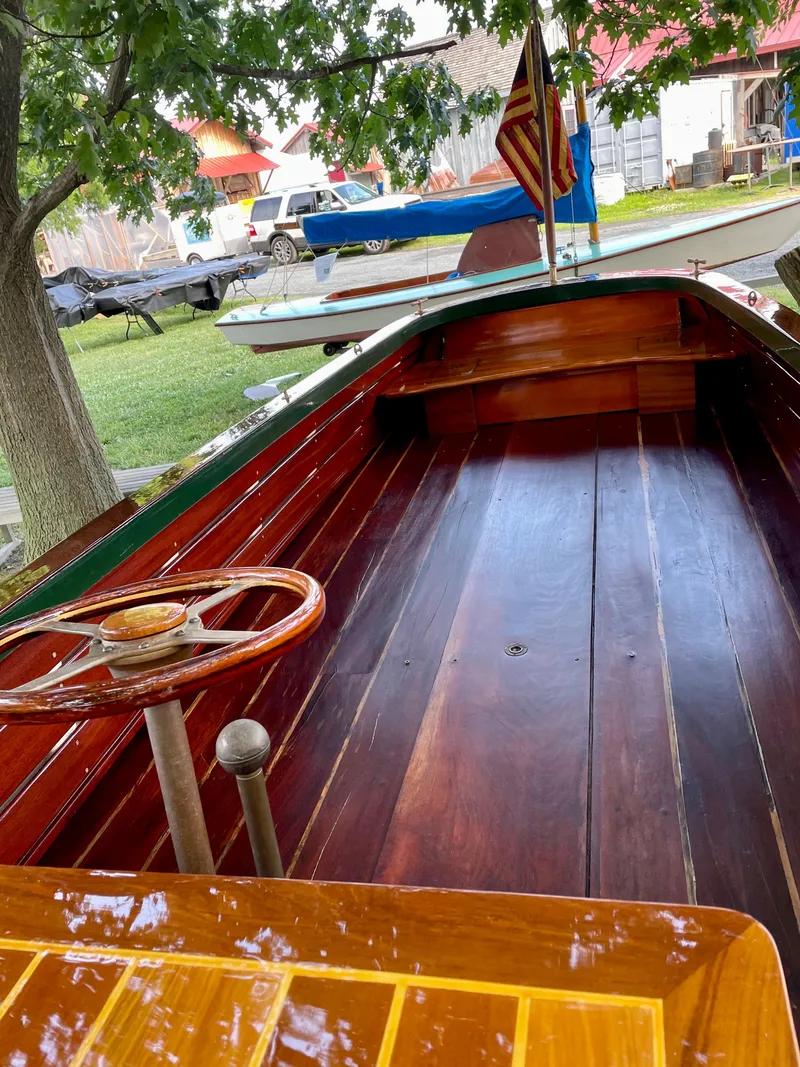 Slide: The Image of Custom 1990 29 Launch boat with wooden interior and American flag. - 18