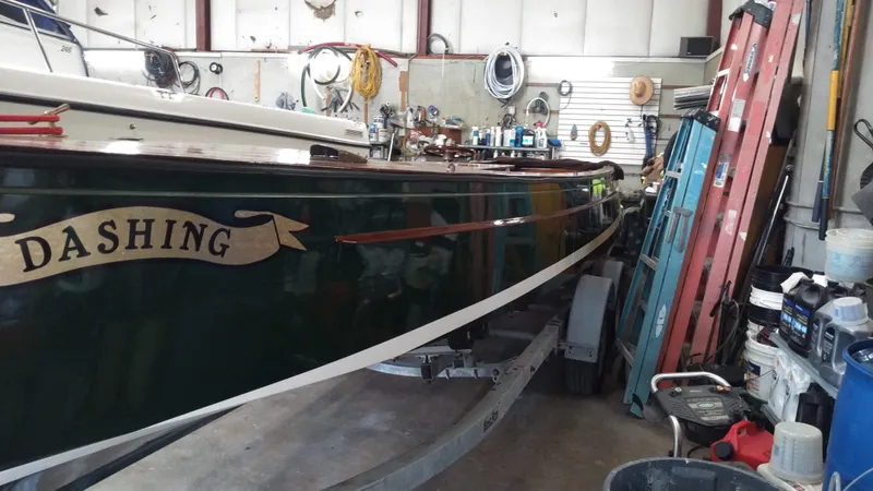 Slide: The Image of Custom 1990 29 Launch boat named 'Dashing' in a workshop for maintenance. - 4
