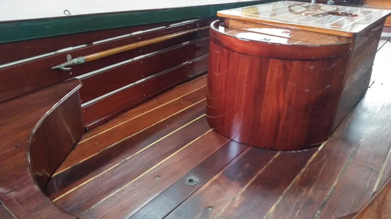 Slide: The Image of Interior of a 1990 Custom 29 Launch boat with polished wooden finish. - 5