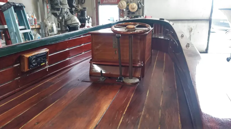 Slide: The Image of Custom 1990 29 Launch boat interior with wooden deck and steering wheel. - 8