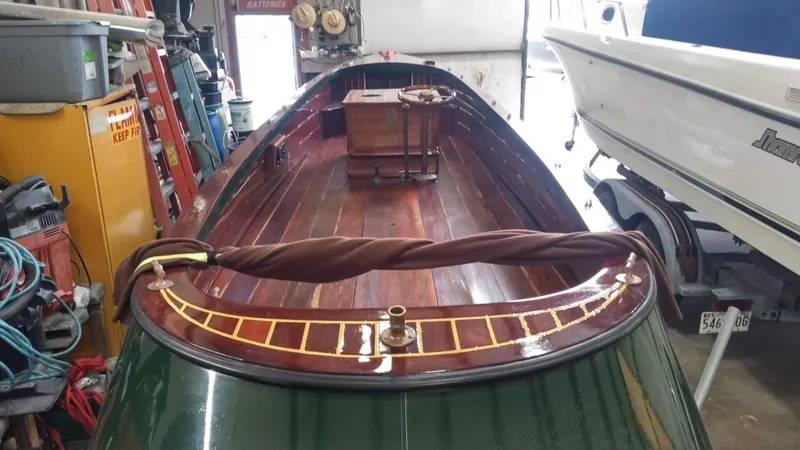 Slide: The Image of Custom 1990 29 Launch boat with polished wooden interior in a garage. - 9