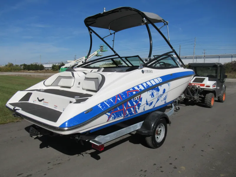 Slide: The Image of 2015 Yamaha Boats AR192 on trailer, rear view with blue and white graphics. - 1
