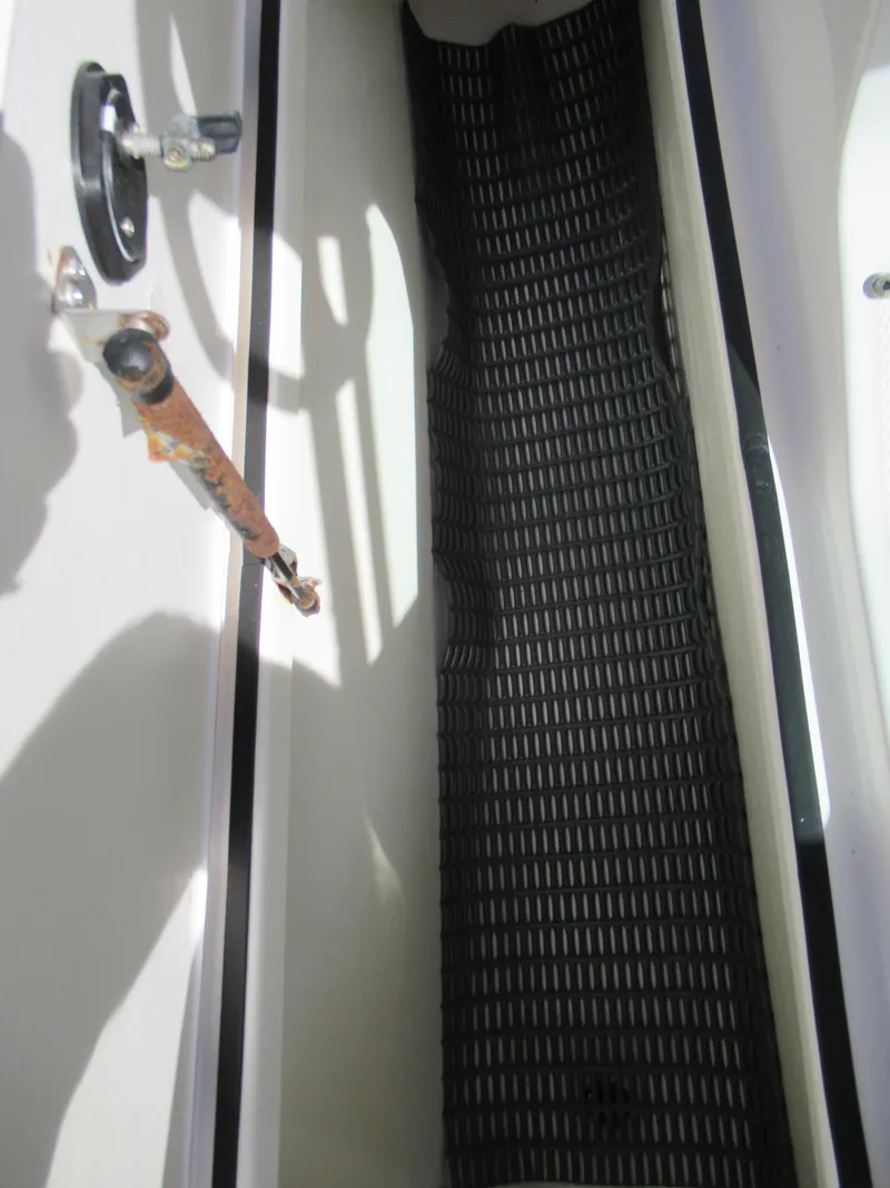Slide: The Image of 2015 Yamaha Boats AR192 storage compartment with black rubber mat. - 13