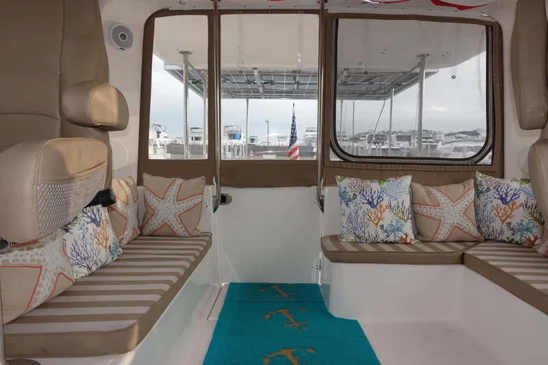 Slide: The Image of Interior of 2019 Endeavour Catamaran 440 HYBRID with seating and decorative pillows. - 11