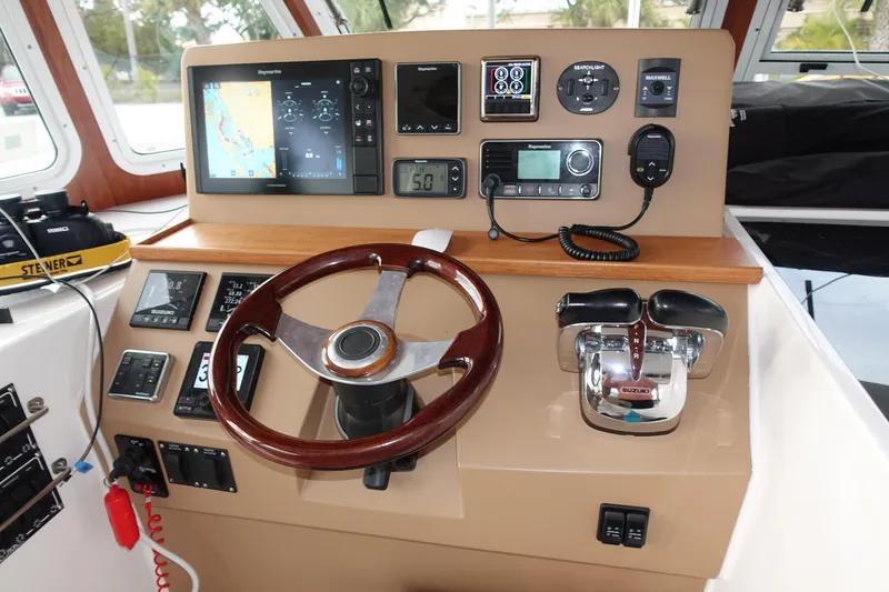 Slide: The Image of Helm station of 2019 Endeavour Catamaran 440 HYBRID with navigation equipment and controls. - 12