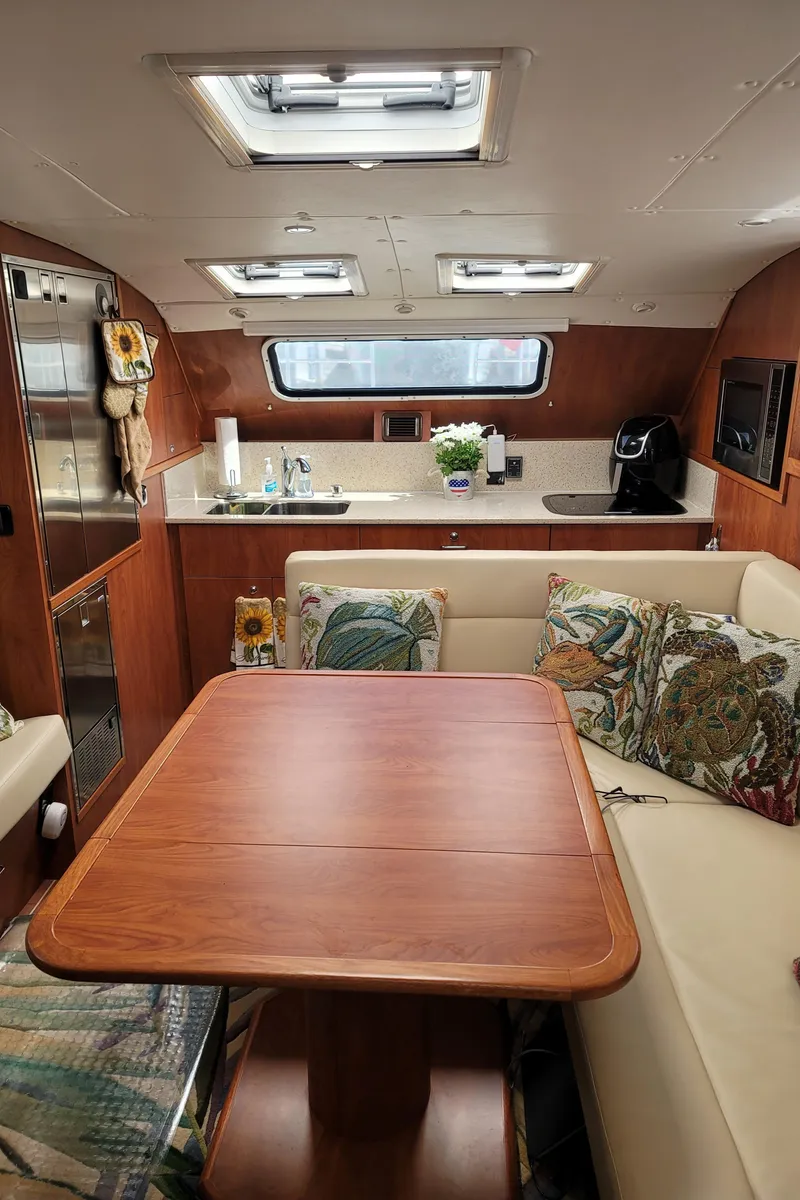 Slide: The Image of 2019 Endeavour Catamaran 440 HYBRID interior with kitchen and dining area. - 5