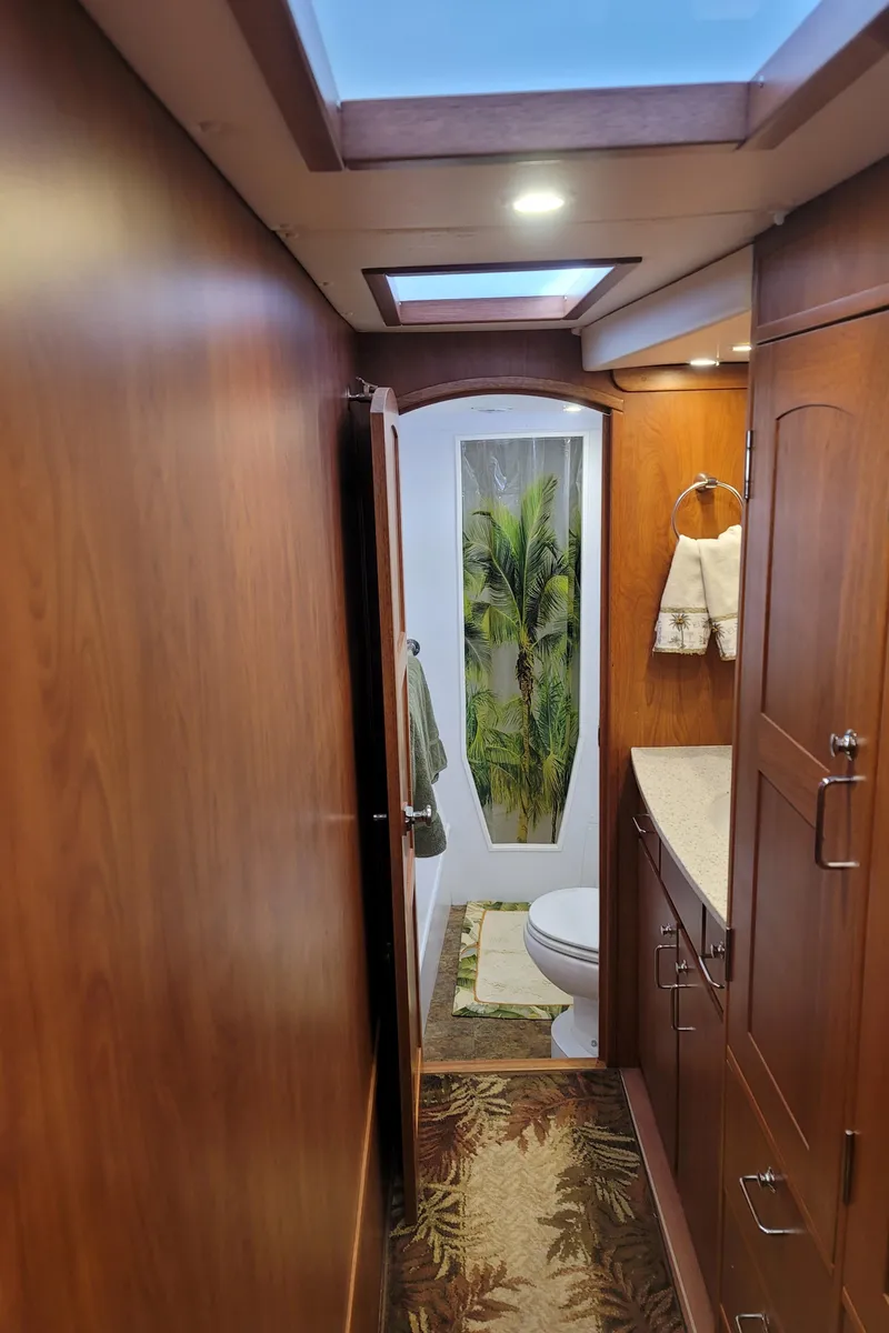 Slide: The Image of Interior of 2019 Endeavour Catamaran 440 HYBRID with wooden cabinetry and bathroom. - 6