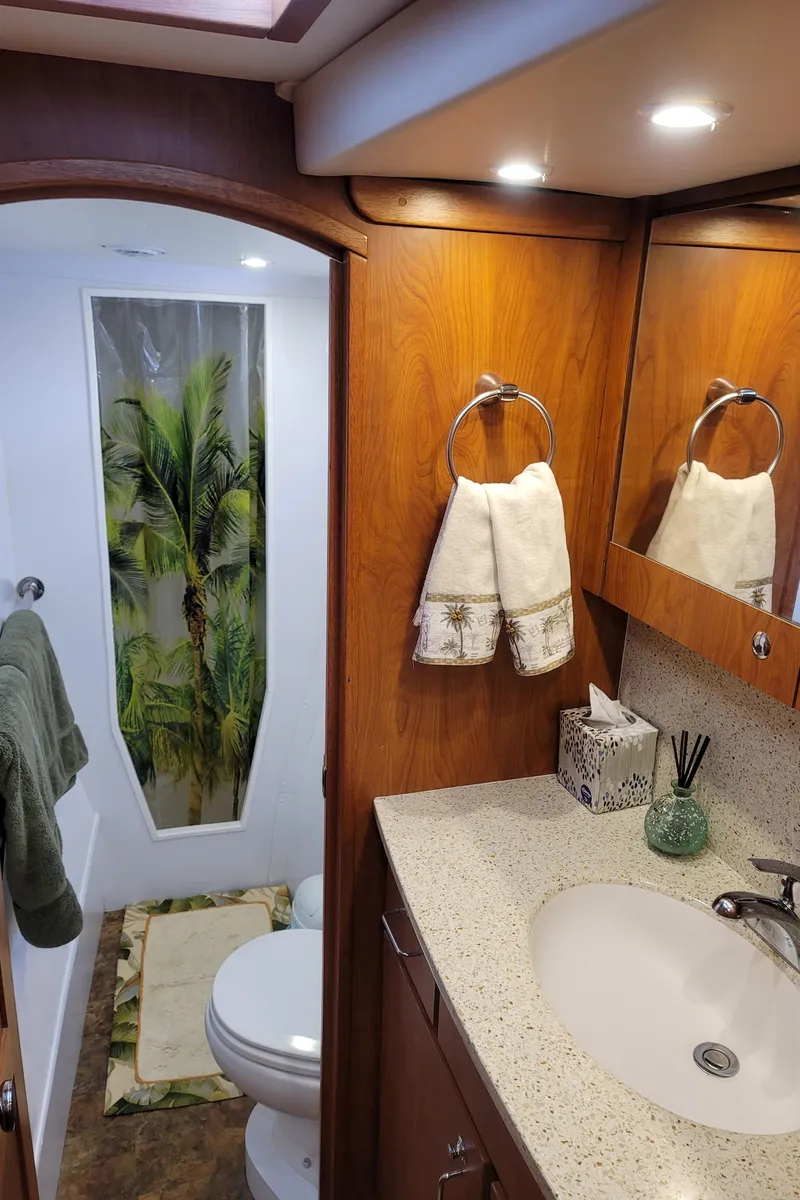 Slide: The Image of 2019 Endeavour Catamaran 440 HYBRID bathroom with modern fixtures and tropical decor. - 7