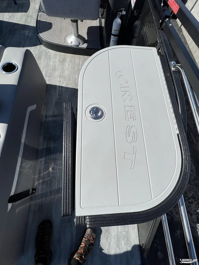 Slide: The Image of 2023 Crest 240 Classic Platinum boat interior with branded storage compartment. - 5
