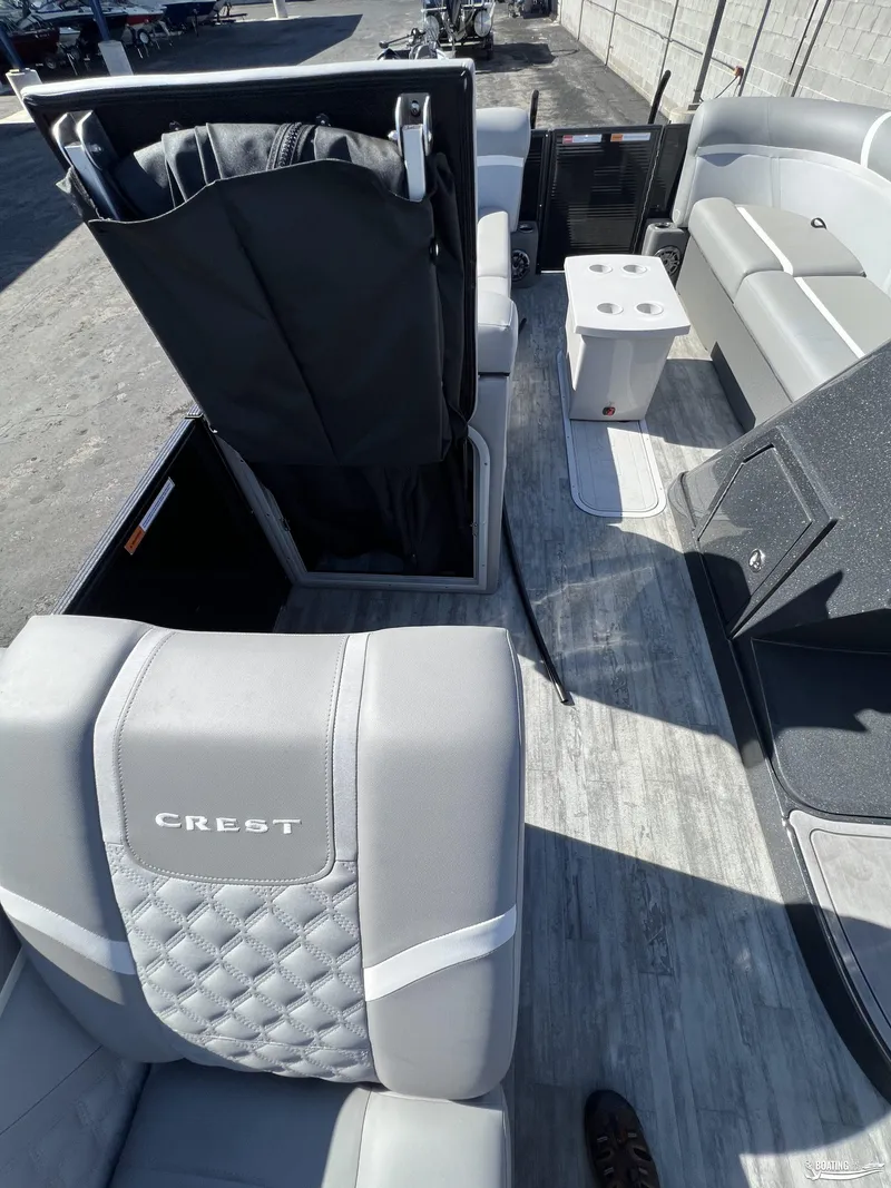 Slide: The Image of 2023 Crest 240 Classic Platinum boat interior with gray seating and modern design. - 9