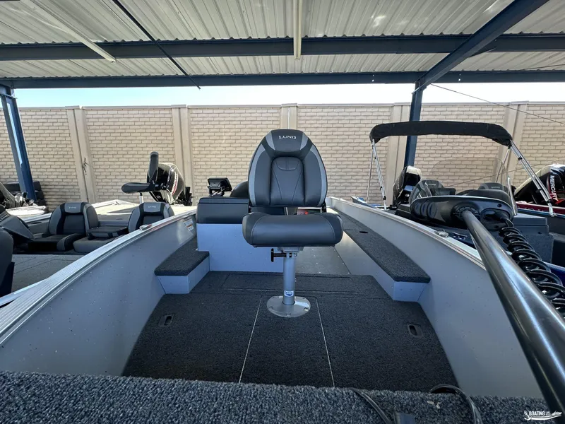 Slide: The Image of 2023 Lund Fury 1600 SS boat interior with seating and equipment under a covered area. - 10