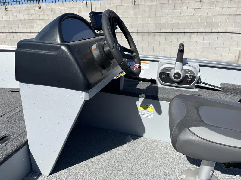 Slide: The Image of 2023 Lund Fury 1600 SS boat interior with steering wheel and control panel. - 3