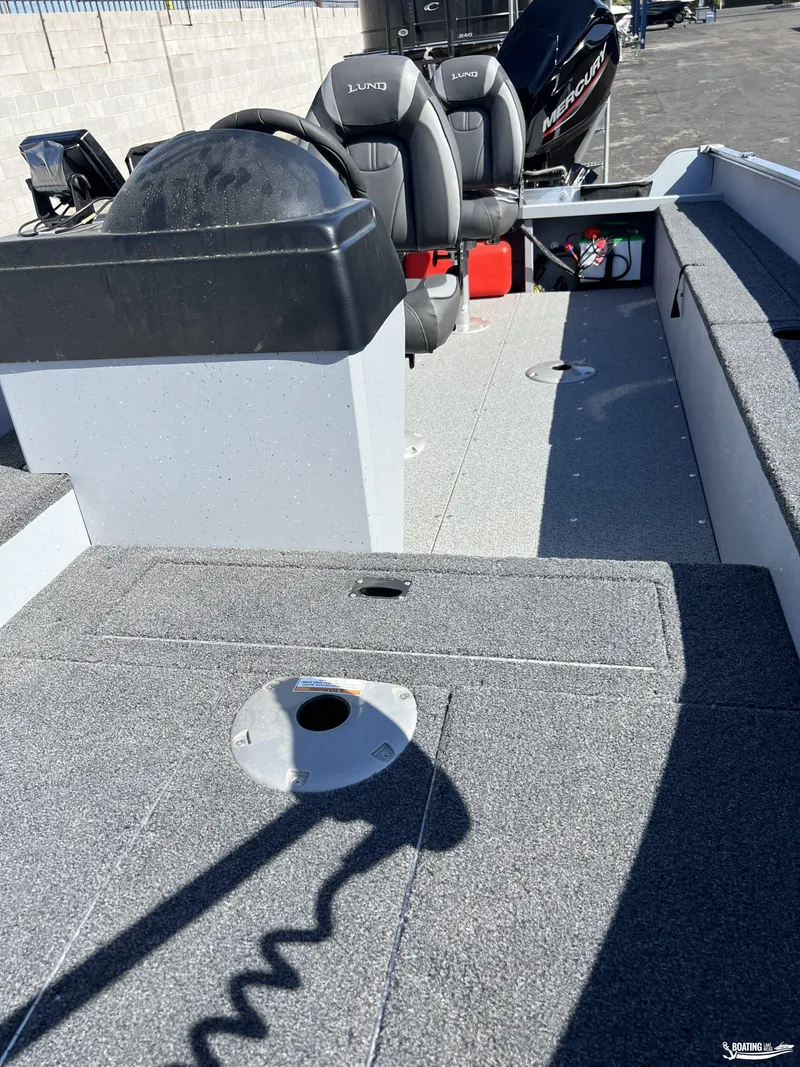 Slide: The Image of 2023 Lund Fury 1600 SS boat interior with seating and Mercury engine. - 4