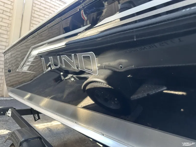 Slide: The Image of 2023 Lund Fury 1600 SS boat side view with logo and trailer. - 6
