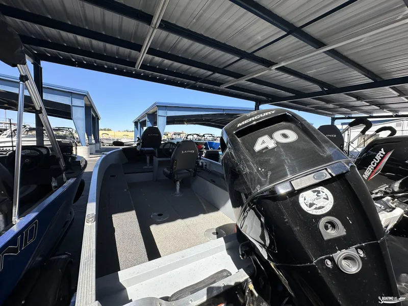 Slide: The Image of 2023 Lund Fury 1600 SS boat with Mercury 40 engine under metal canopy. - 7
