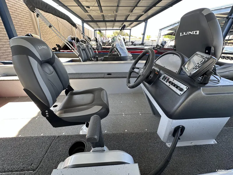 Slide: The Image of 2023 Lund Fury 1600 SS boat interior with steering console and seating. - 9