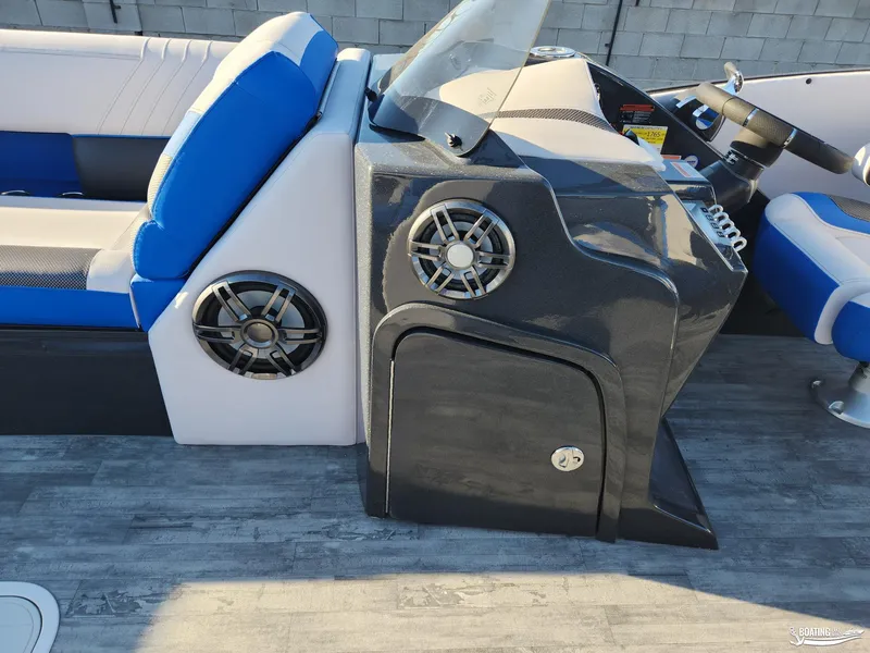 Slide: The Image of 2023 Crest Caribbean RS 250 SLS boat interior with blue seating and modern dashboard. - 15