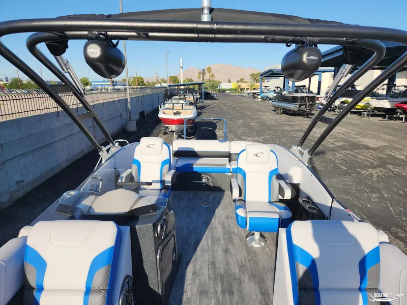 Slide: The Image of 2023 Crest Caribbean RS 250 SLS pontoon boat interior with blue and white seating. - 17