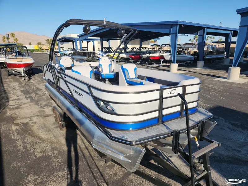 Slide: The Image of 2023 Crest Caribbean RS 250 SLS pontoon boat in a marina setting. - 3