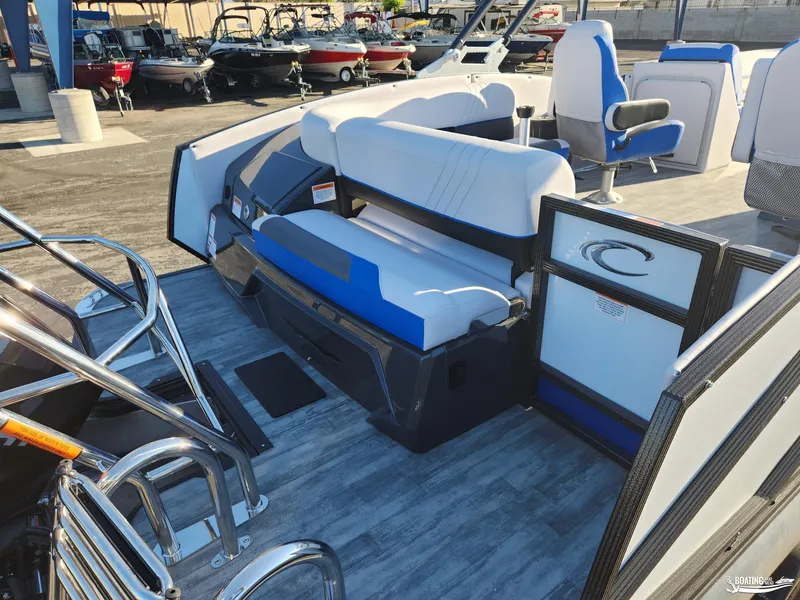 Slide: The Image of 2023 Crest Caribbean RS 250 SLS boat interior with blue and white seating. - 5