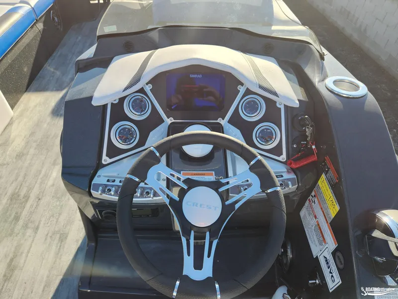 Slide: The Image of 2023 Crest Caribbean RS 250 SLS boat dashboard with steering wheel and control panel. - 8