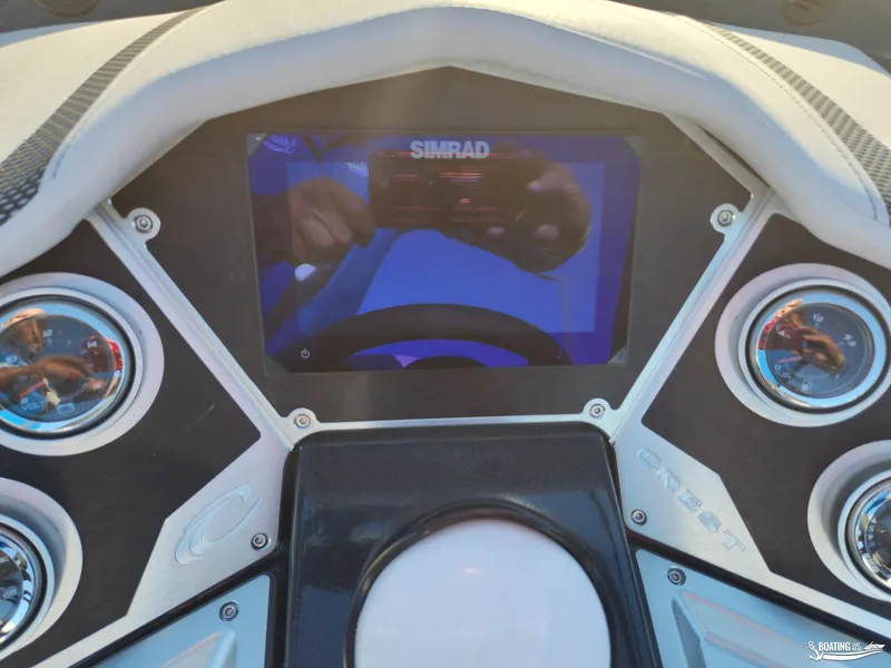 Slide: The Image of Dashboard of 2023 Crest Caribbean RS 250 SLS with Simrad display and gauges. - 9