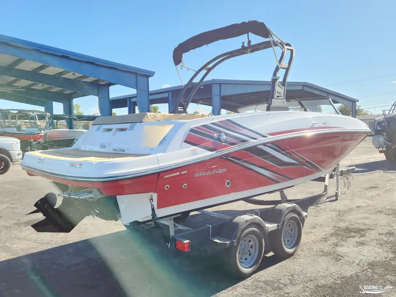 Slide: The Image of 2023 Bayliner VR6 boat on trailer, red and white design, parked outdoors. - 2