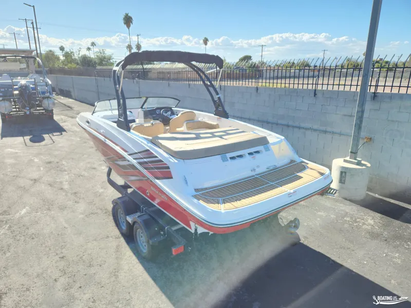 Slide: The Image of 2023 Bayliner VR6 boat on trailer, parked outdoors under clear sky. - 3