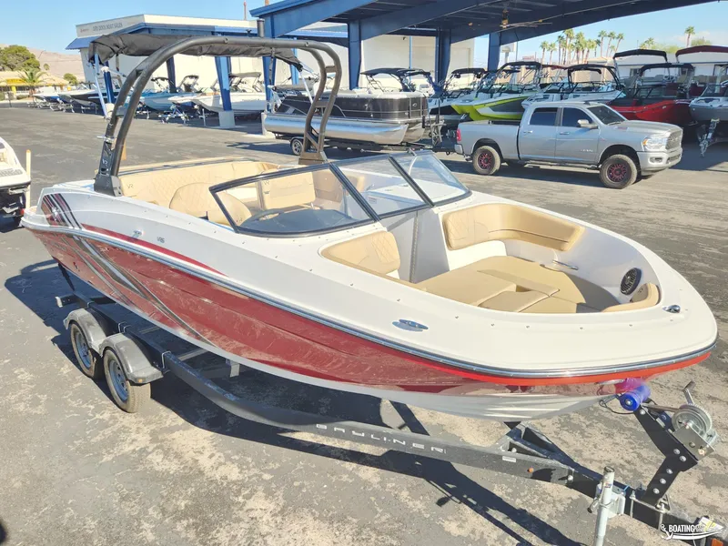 Slide: The Image of 2023 Bayliner VR6 boat on trailer at dealership, featuring sleek design and spacious seating. - 6