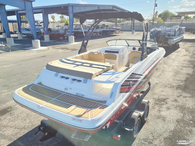 Slide: The Image of 2023 Bayliner VR6 boat on trailer, showcased in a marina setting. - 8