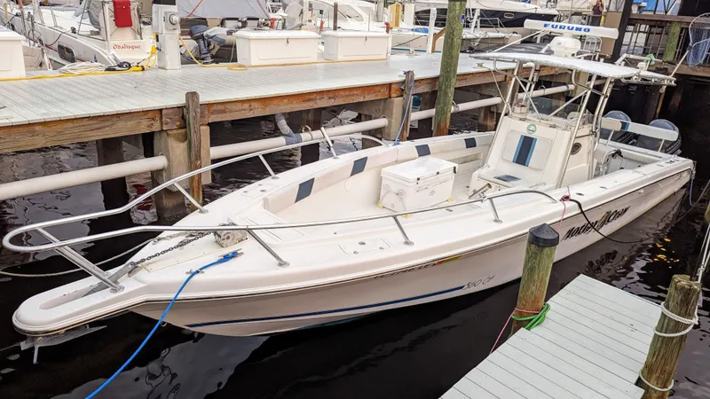 Slide: The Image of Al Dhaen 360 Open Fisher 2000 model docked at a marina. - 3