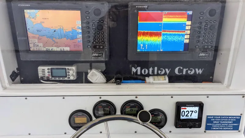 Slide: The Image of Boat dashboard with Furuno navigation and sonar systems, Yamaha gauges, and Raymarine compass on Al Dhaen 360 Open Fisher. - 7