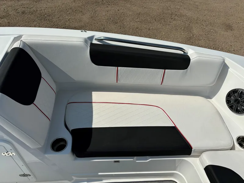 Slide: The Image of 2023 Tahoe 1950 boat interior with black and white seating, red accents, and cup holder. - 17