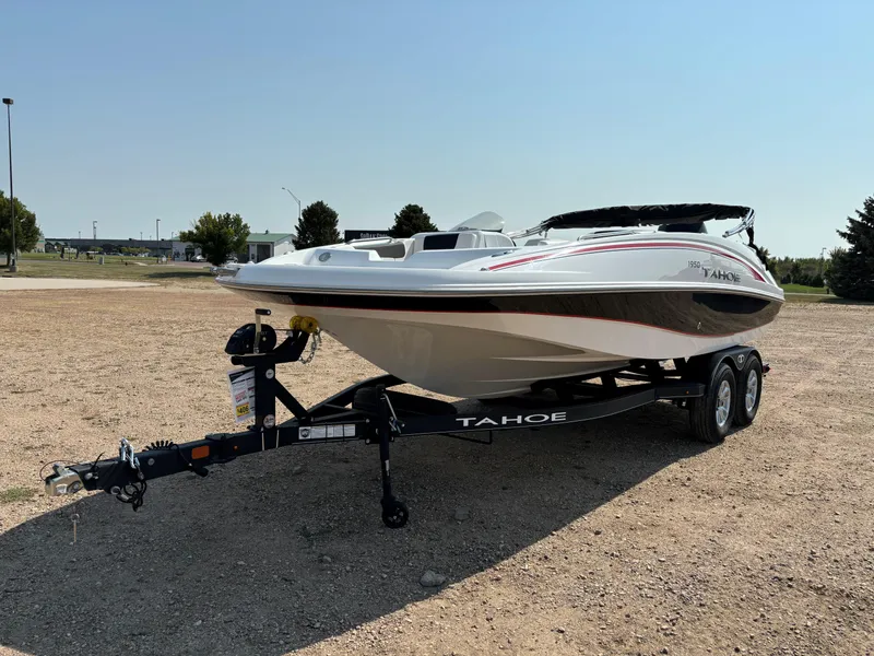 Slide: The Image of 2023 Tahoe 1950 boat on trailer in outdoor setting. - 2