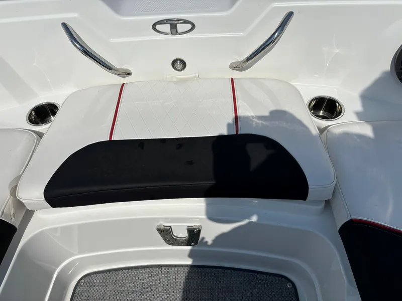 Slide: The Image of 2023 Tahoe 1950 boat interior with white and black seating, cup holders, and logo. - 20