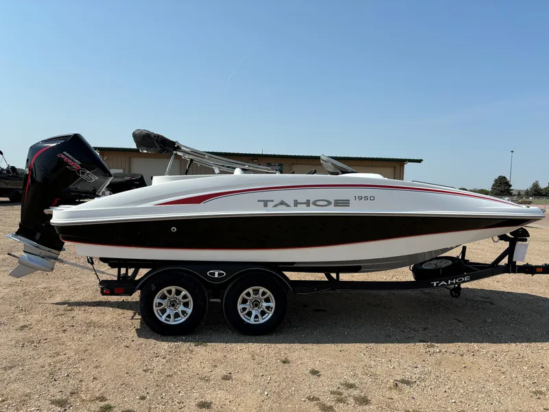 Slide: The Image of 2023 Tahoe 1950 boat on trailer, white and black design, outdoor setting. - 4