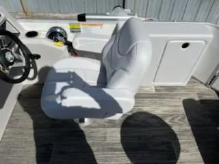 Slide: The Image of 2023 Sweetwater 2086C boat interior with captain's chair and steering wheel. - 5