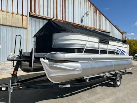Slide: The Image of 2023 Sweetwater 2086C pontoon boat on a trailer, covered with a black tarp. - 8