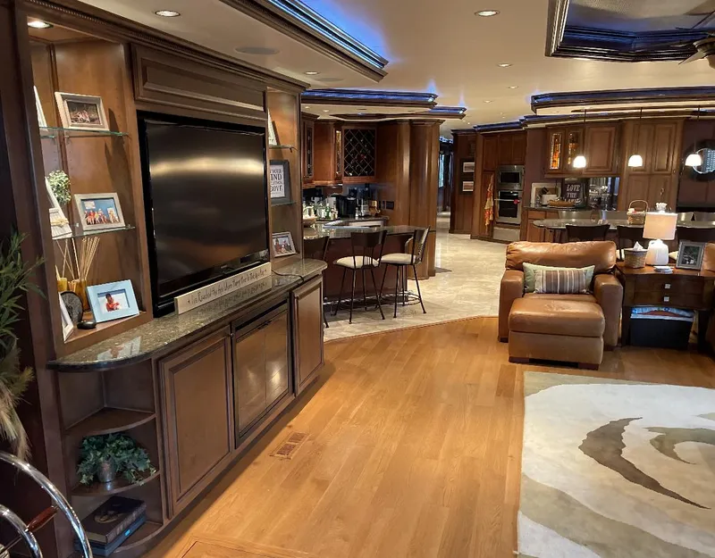 Slide: The Image of Luxurious 2009 Sumerset houseboat interior with modern kitchen, cozy seating, and elegant wood finishes. - 19