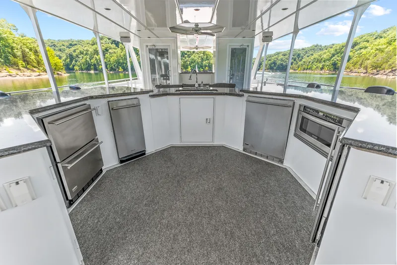 Slide: The Image of Luxurious 2009 Sumerset houseboat kitchen with modern appliances and scenic lake view. - 29