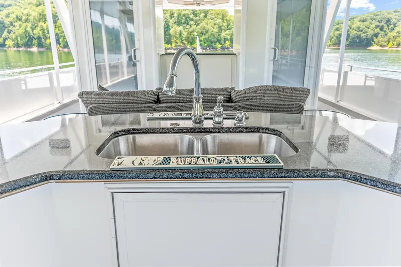 Slide: The Image of Luxurious kitchen area on a 2009 Sumerset houseboat with sleek countertops and modern sink. - 30