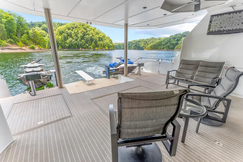 Slide: The Image of Spacious deck of 2009 Sumerset houseboat with seating, overlooking serene lake and lush greenery. - 42
