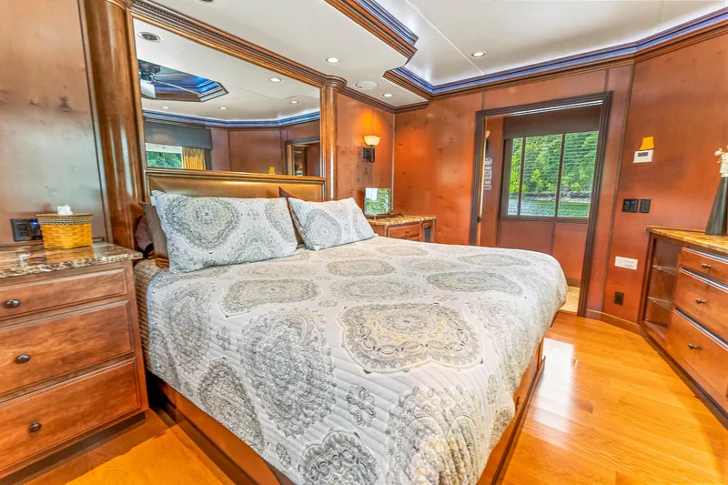 Slide: The Image of Luxurious bedroom in 2009 Sumerset houseboat with elegant wood paneling and large bed. - 48
