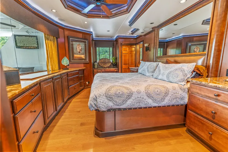 Slide: The Image of Luxurious bedroom interior in 2009 Sumerset houseboat, featuring elegant wood cabinetry and cozy bedding. - 49