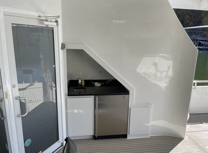 Slide: The Image of Outdoor kitchenette on a 2009 Sumerset Amy Chris houseboat with sink and mini-fridge. - 8