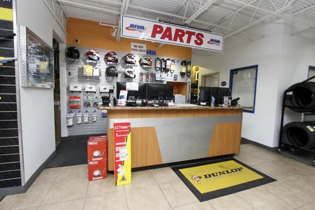 Slide: The Image of Parts counter in a Yamaha Waverunners dealership, showcasing helmets and accessories. - 17